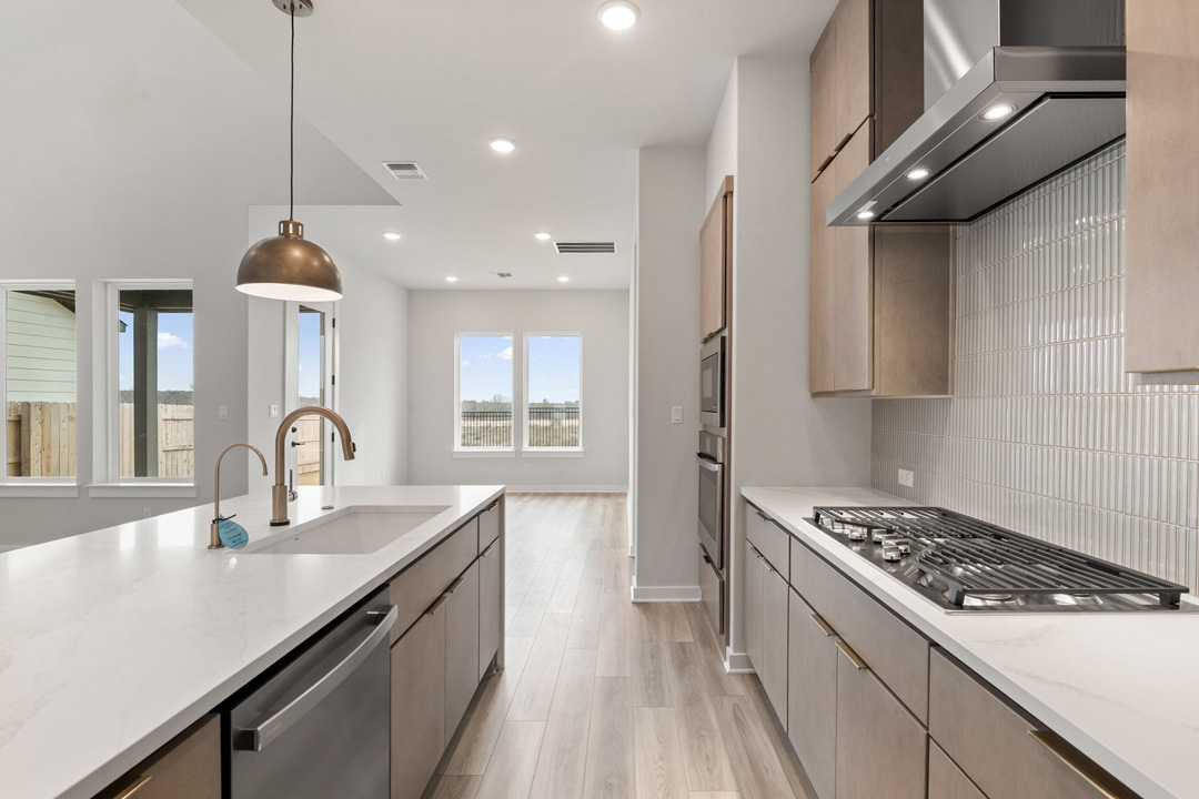 16209 Smithers Road Manor, TX 78653 - Photo 7 of 38 a kitchen with stainless steel appliances a sink stove and cabinets