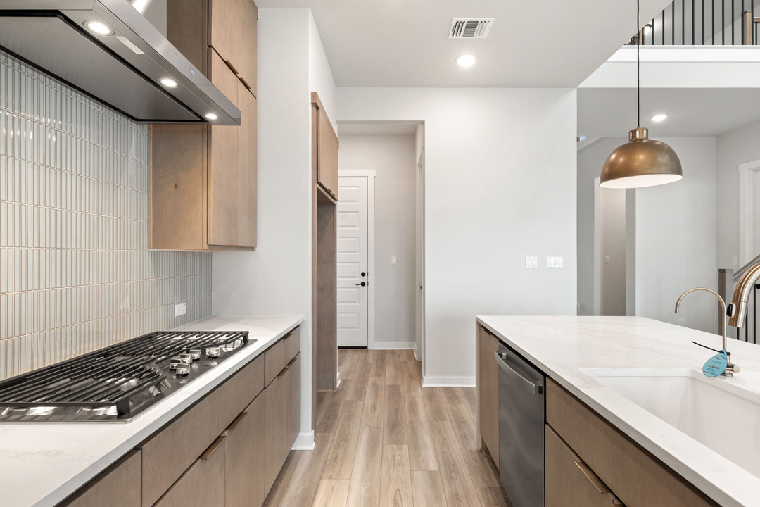 16209 Smithers Road Manor, TX 78653 - Photo 8 of 38 a kitchen with a sink and a stove top oven