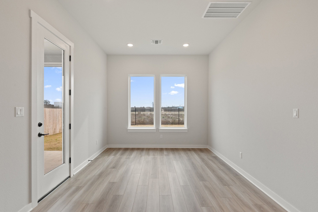 16209 Smithers Road Manor, TX 78653 - Photo 9 of 38 an empty room with wooden floor and windows