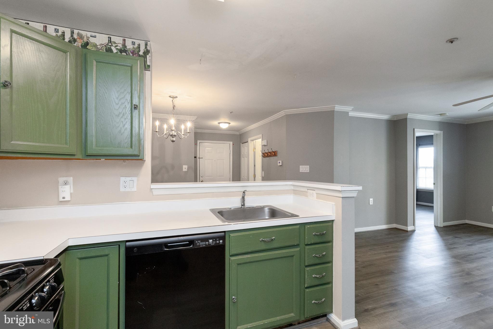 1049 Gardenview Loop, Unit 301 Woodbridge, VA 22191 - Photo 12 of 25 a kitchen with a sink and a mirror