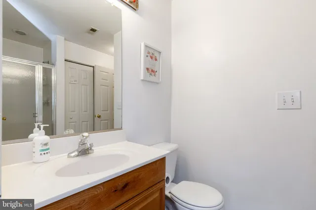 a bathroom with a sink toilet and mirror