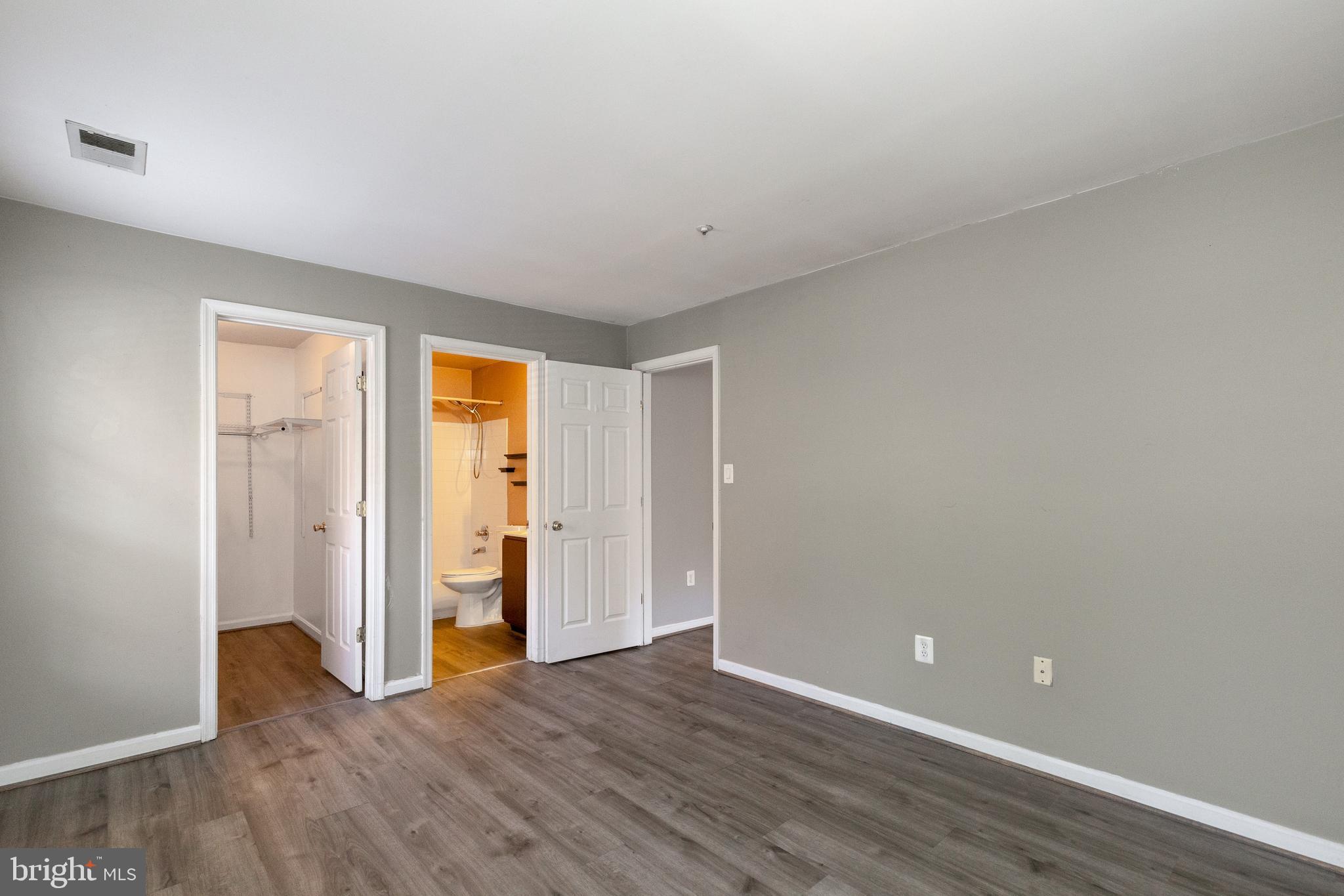1049 Gardenview Loop, Unit 301 Woodbridge, VA 22191 - Photo 21 of 25 a view of an empty room with wooden floor and closet