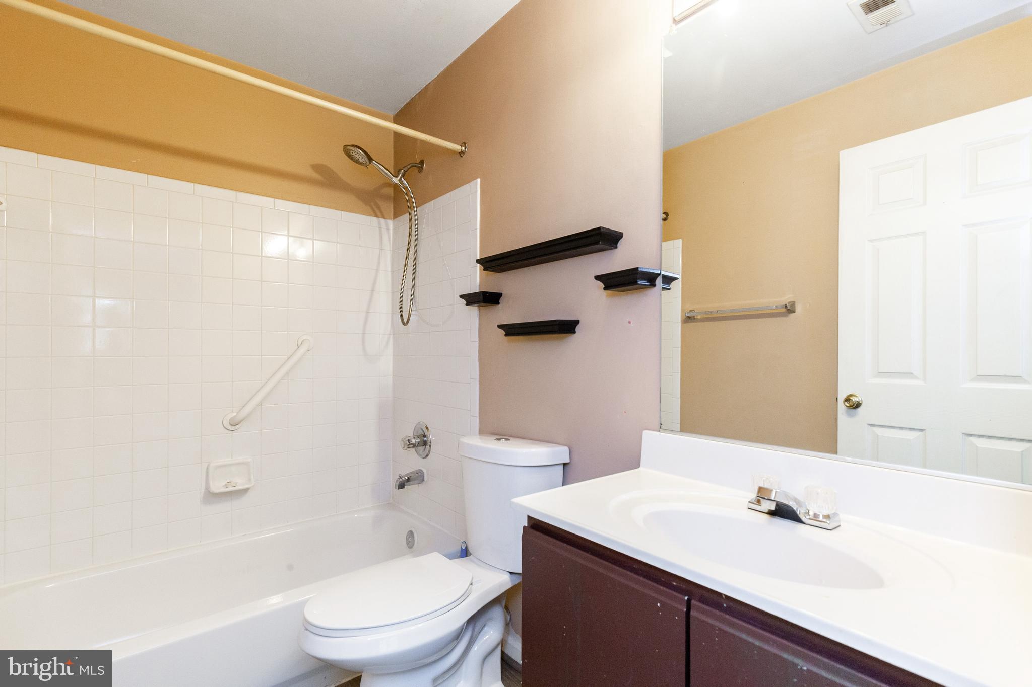 1049 Gardenview Loop, Unit 301 Woodbridge, VA 22191 - Photo 24 of 25 a bathroom with a sink toilet and shower