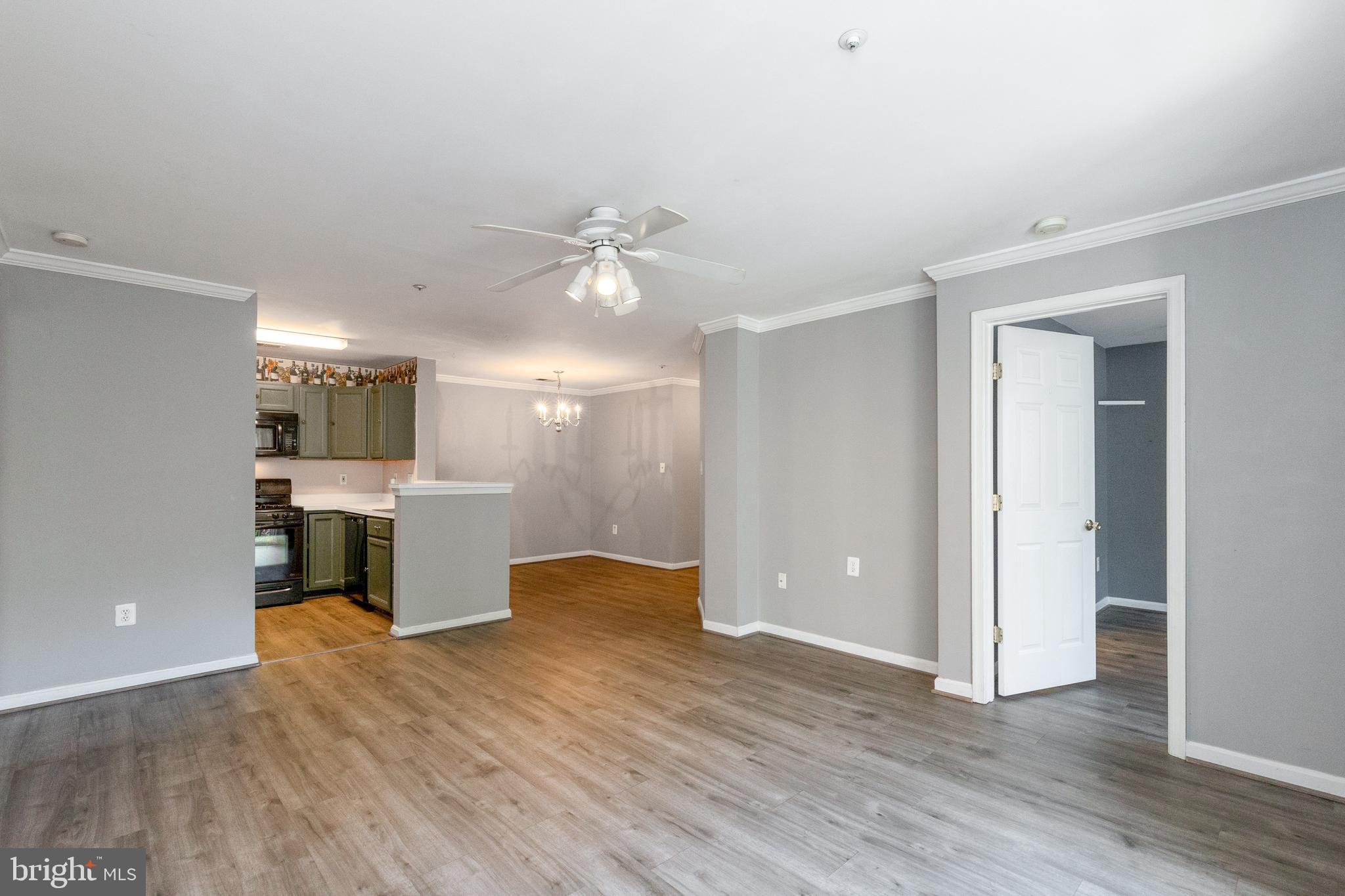 1049 Gardenview Loop, Unit 301 Woodbridge, VA 22191 - Photo 7 of 25 a view of a kitchen with a sink and a refrigerator