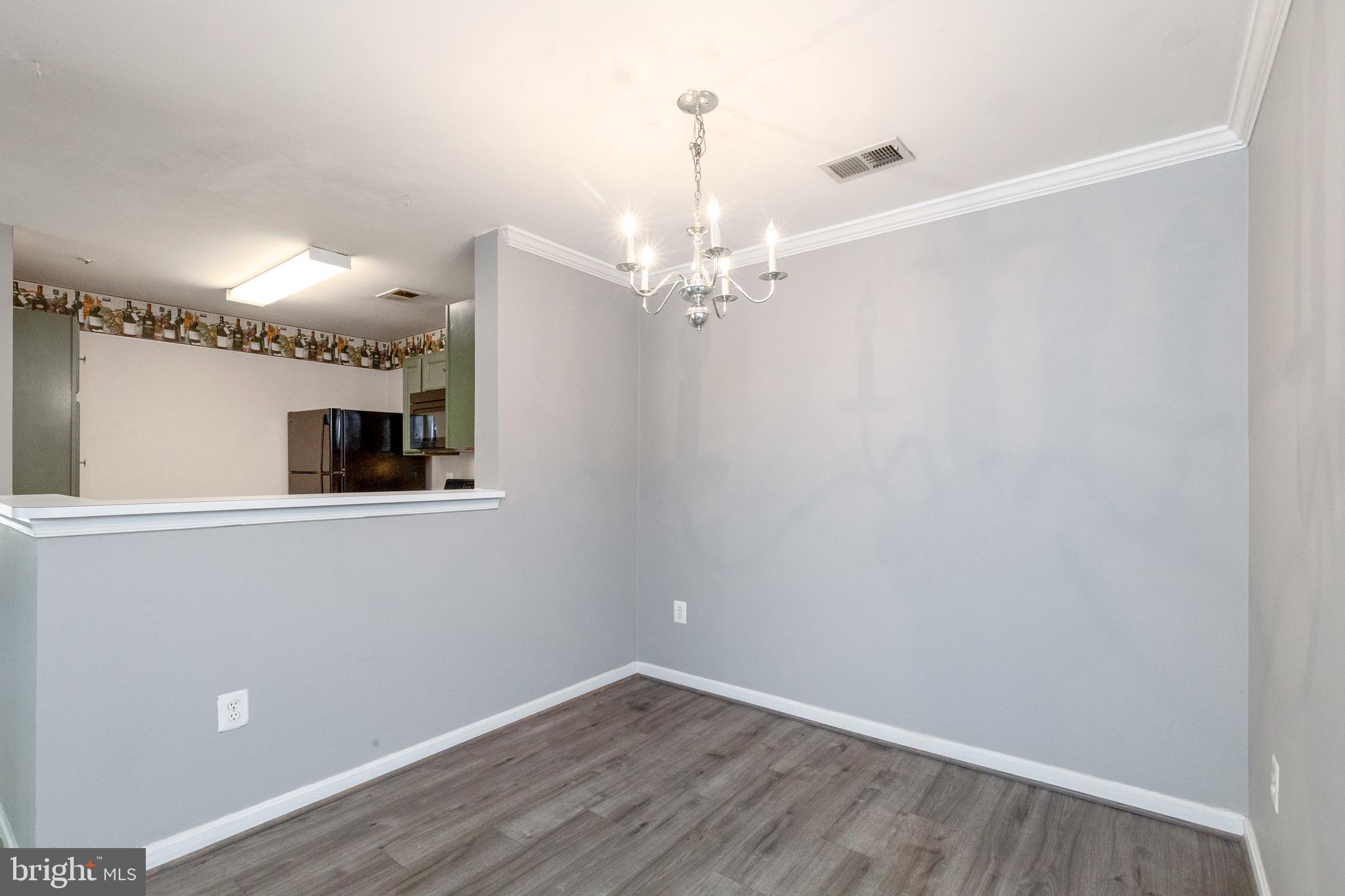 1049 Gardenview Loop, Unit 301 Woodbridge, VA 22191 - Photo 8 of 25 a view of a hallway with chandelier and entryway