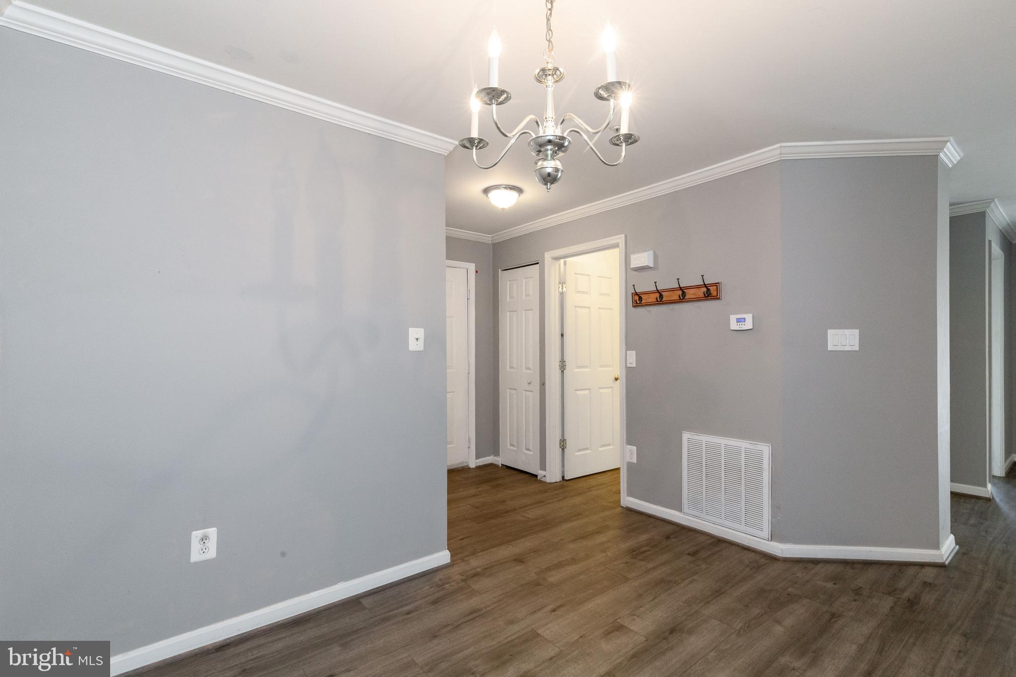 1049 Gardenview Loop, Unit 301 Woodbridge, VA 22191 - Photo 9 of 25 a view of an empty room with wooden floor