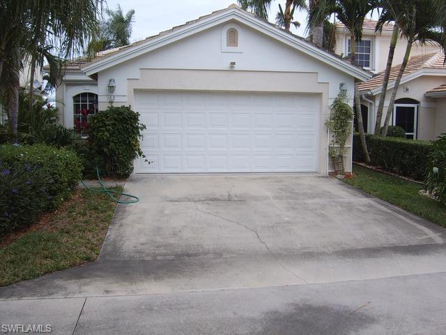 162 Eveningstar Cay Naples, FL 34114 - Photo 1 of 8 a front view of a house with a yard and garage