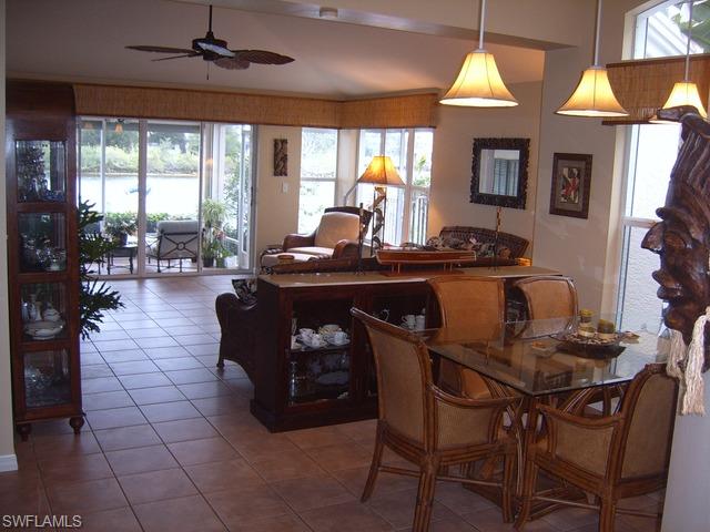 162 Eveningstar Cay Naples, FL 34114 - Photo 2 of 8 a living room with furniture and a large window