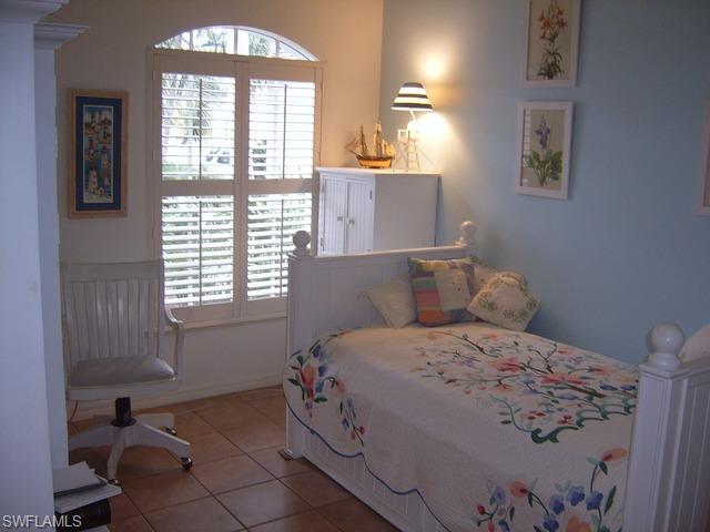 162 Eveningstar Cay Naples, FL 34114 - Photo 6 of 8 a bedroom with a bed and a window