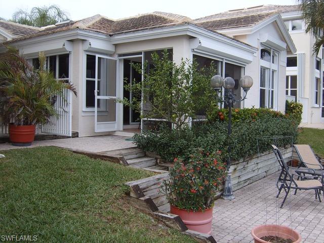 162 Eveningstar Cay Naples, FL 34114 - Photo 7 of 8 a view of a house with backyard and sitting area