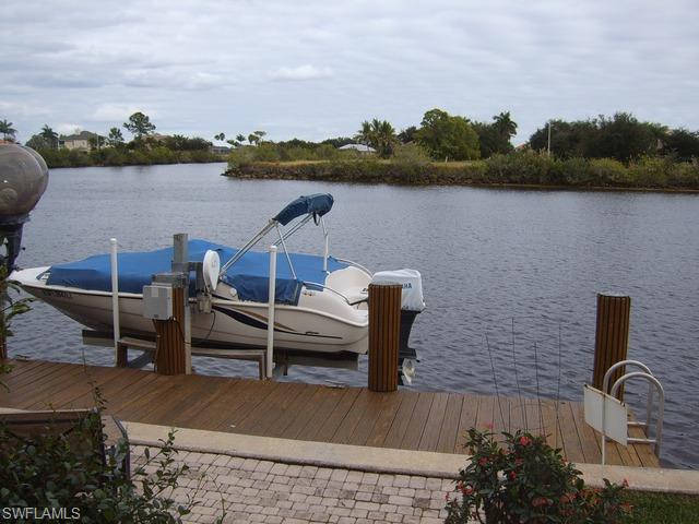 162 Eveningstar Cay Naples, FL 34114 - Photo 8 of 8 a front view of a lake with boats and city view