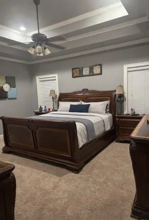 a bedroom with a bed and a chandelier