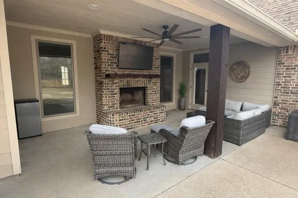 a living room with furniture and a fireplace