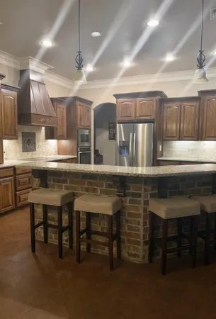 a kitchen with a table chairs sink and cabinets
