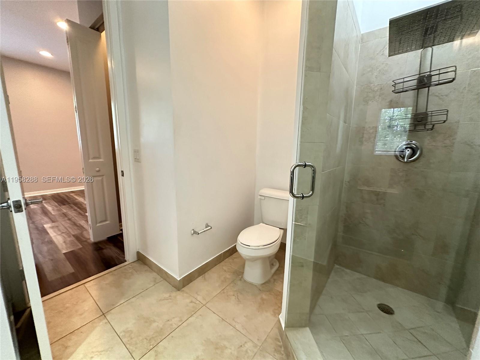 2574 Southwest 81st Terrace, Unit 2564 Miramar, FL 33025 - Photo 13 of 19 a bathroom with a toilet and a shower