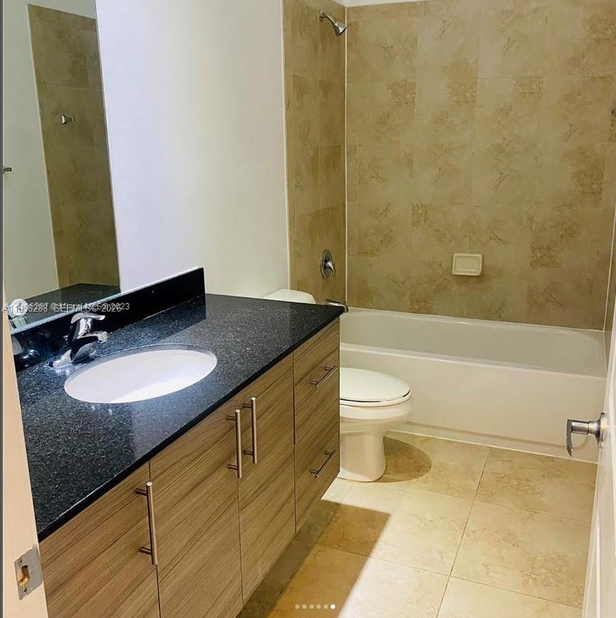 2574 Southwest 81st Terrace, Unit 2564 Miramar, FL 33025 - Photo 16 of 19 a bathroom with a granite countertop sink toilet and shower