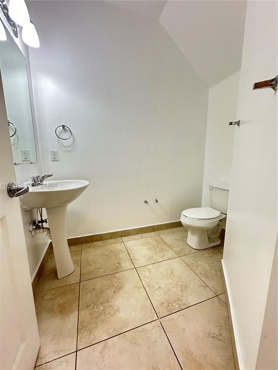 2574 Southwest 81st Terrace, Unit 2564 Miramar, FL 33025 - Photo 7 of 19 a bathroom with a sink toilet and shower