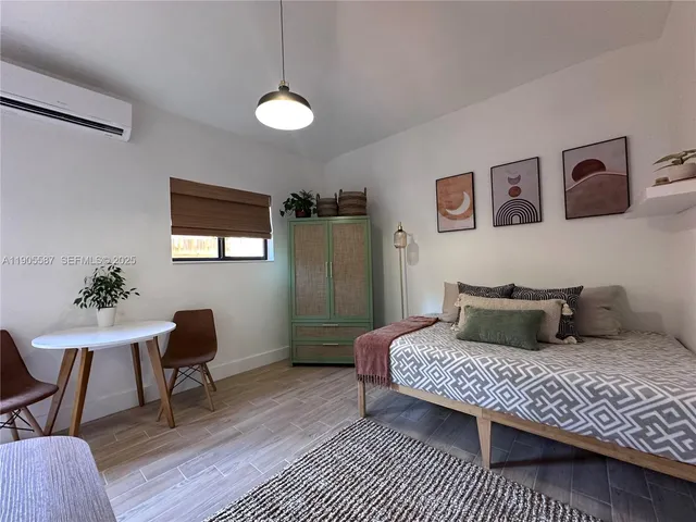 a bedroom with a bed and a chair