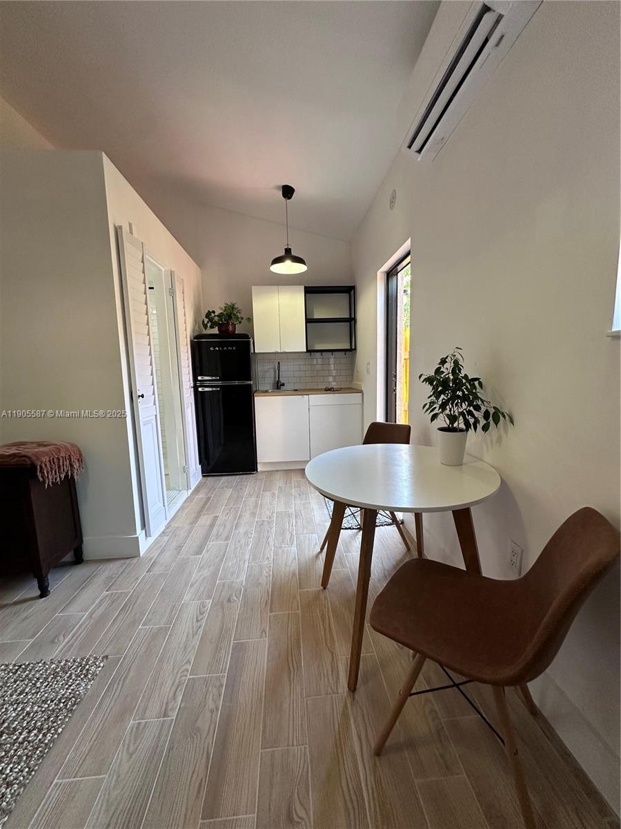 52 Northwest 68th Street, Unit R Miami, FL 33150 - Photo 11 of 19 a view of a dining room with furniture and wooden floor