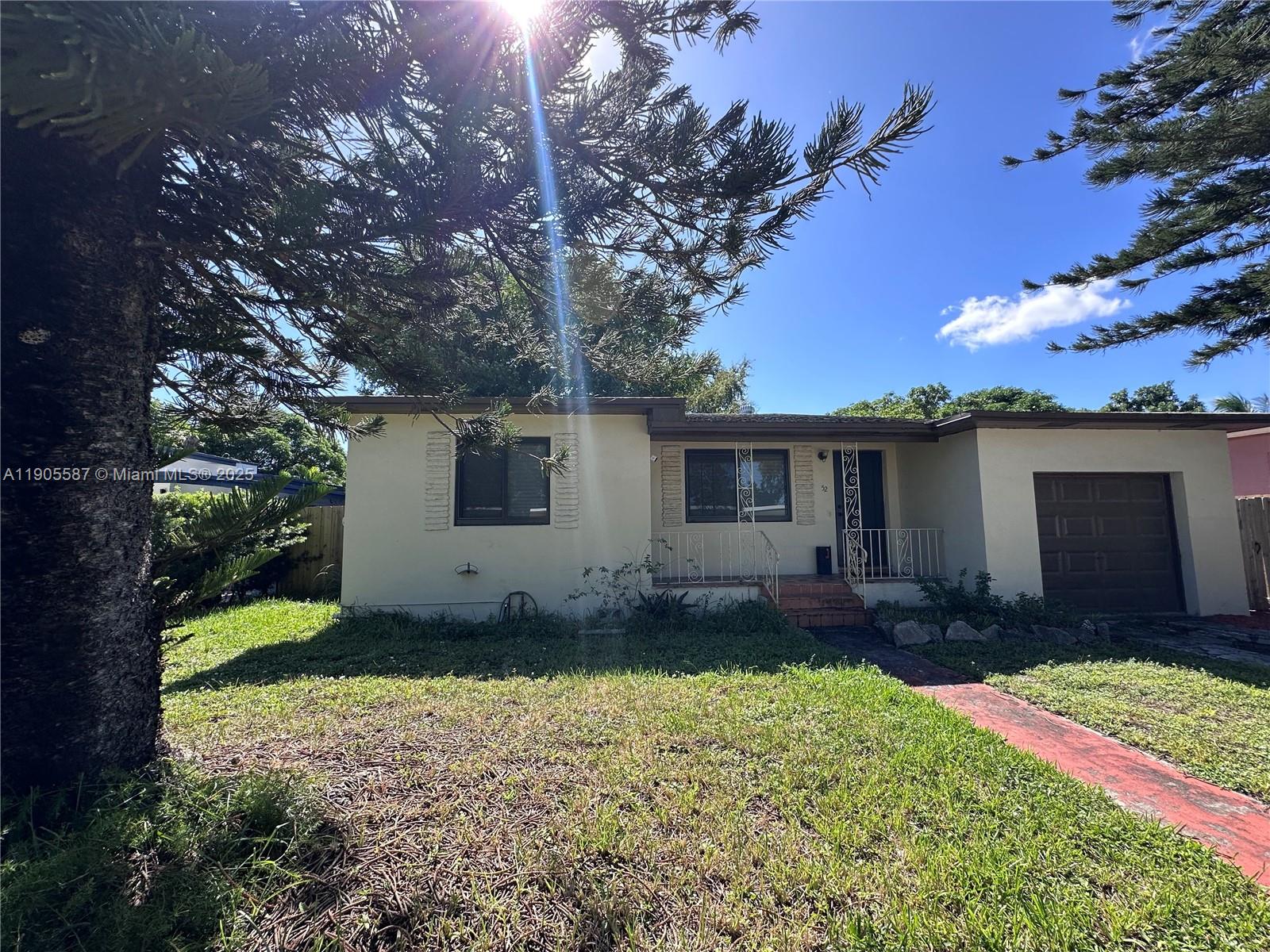 52 Northwest 68th Street, Unit R Miami, FL 33150 - Photo 19 of 19 a view of a house with a yard