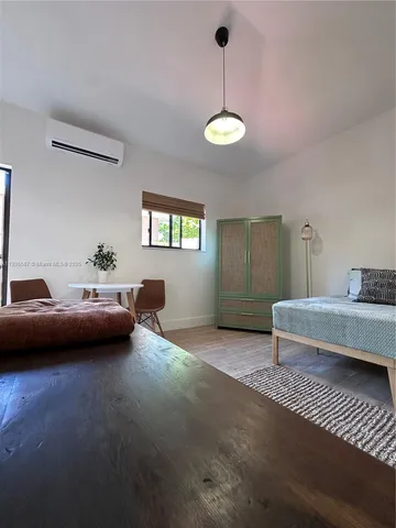a bedroom with furniture and a chandelier