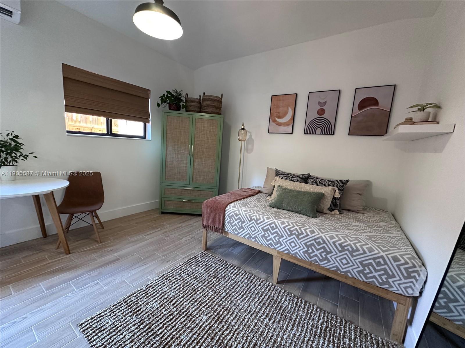 52 Northwest 68th Street, Unit R Miami, FL 33150 - Photo 9 of 19 a bedroom with a bed and a desk