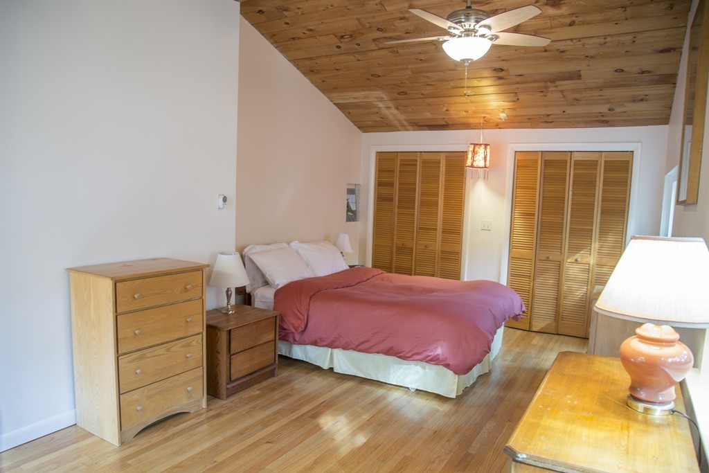 275 Littleton Road Harvard, MA 01451 - Photo 6 of 17 a bedroom with a bed and a chandelier