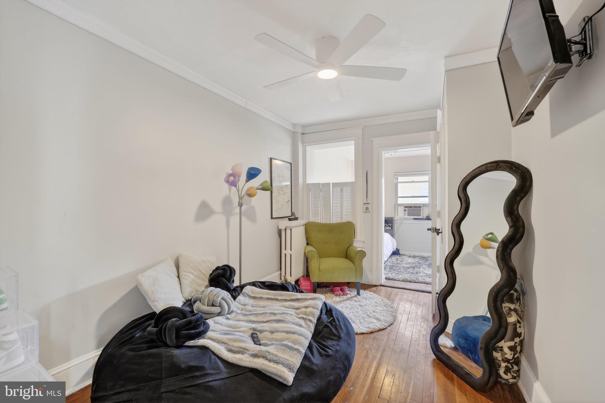4301 4th Street Northwest Washington, DC 20011 - Photo 33 of 65 a bedroom with furniture and a wooden floor