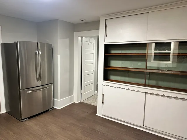 a kitchen with a refrigerator and a stove