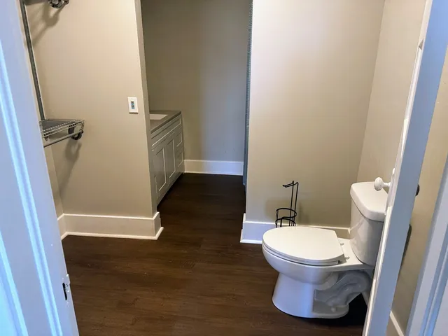 a white toilet sitting next to a bathroom sink