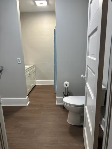 a bathroom with a toilet and a shower