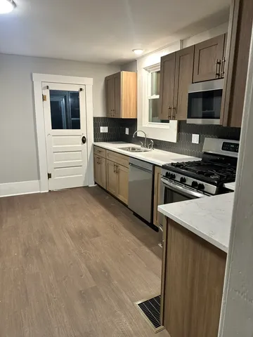 a kitchen with a refrigerator stove and microwave