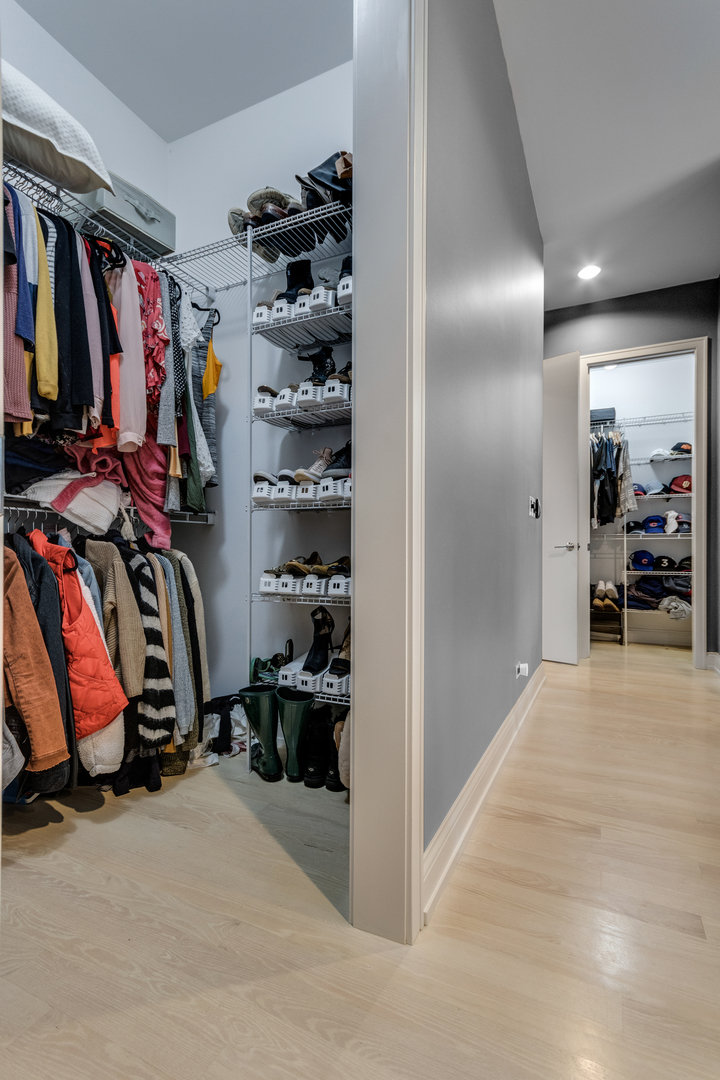 Undisclosed Address Chicago, IL 60622 - Photo 11 of 24 a view of walk in closet with clothes and shoes