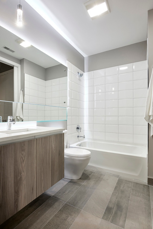 Undisclosed Address Chicago, IL 60622 - Photo 16 of 24 a bathroom with a bathtub a sink a toilet and a mirror