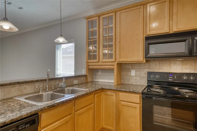 a kitchen with granite countertop a sink and a stove