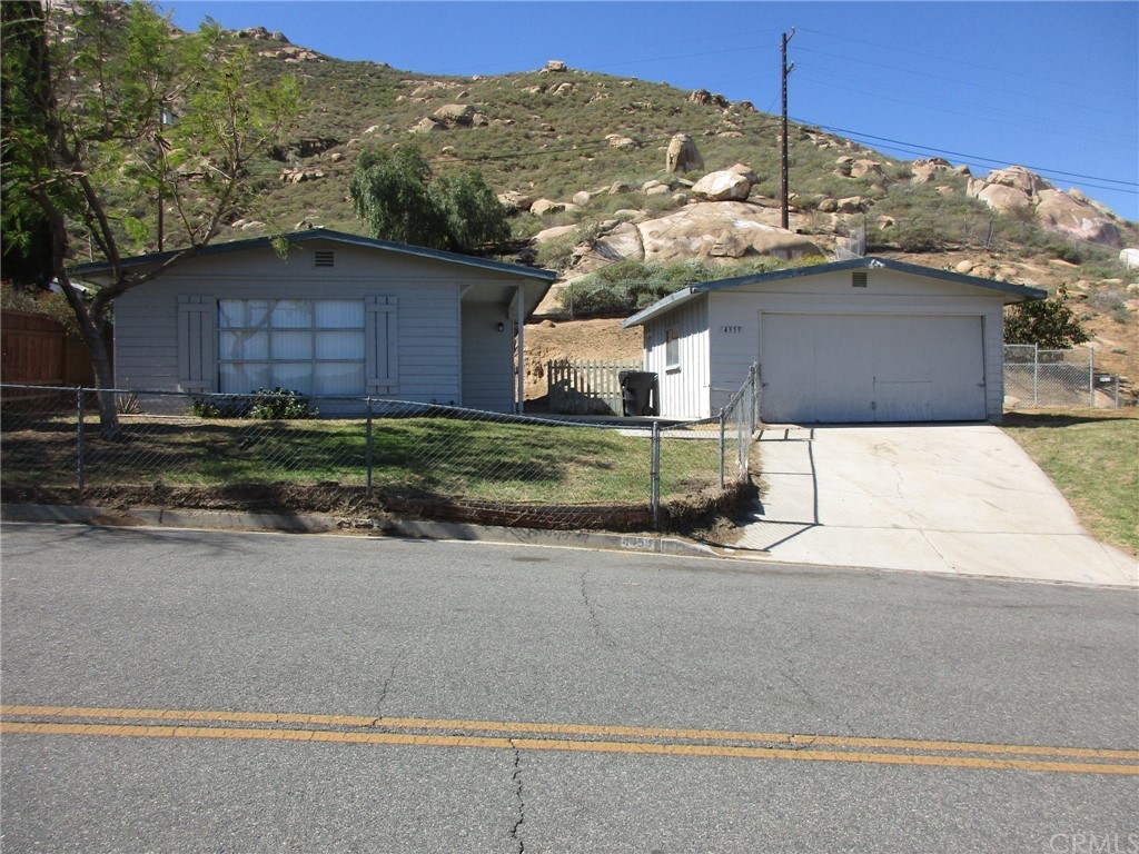 4359 Estrada Drive Riverside, CA 92509 - Photo 1 of 1 a front view of a house with a yard and garage