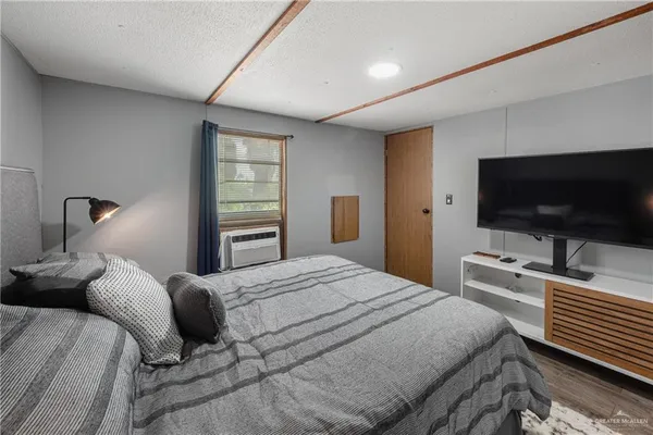 a bedroom with a bed and a flat screen tv