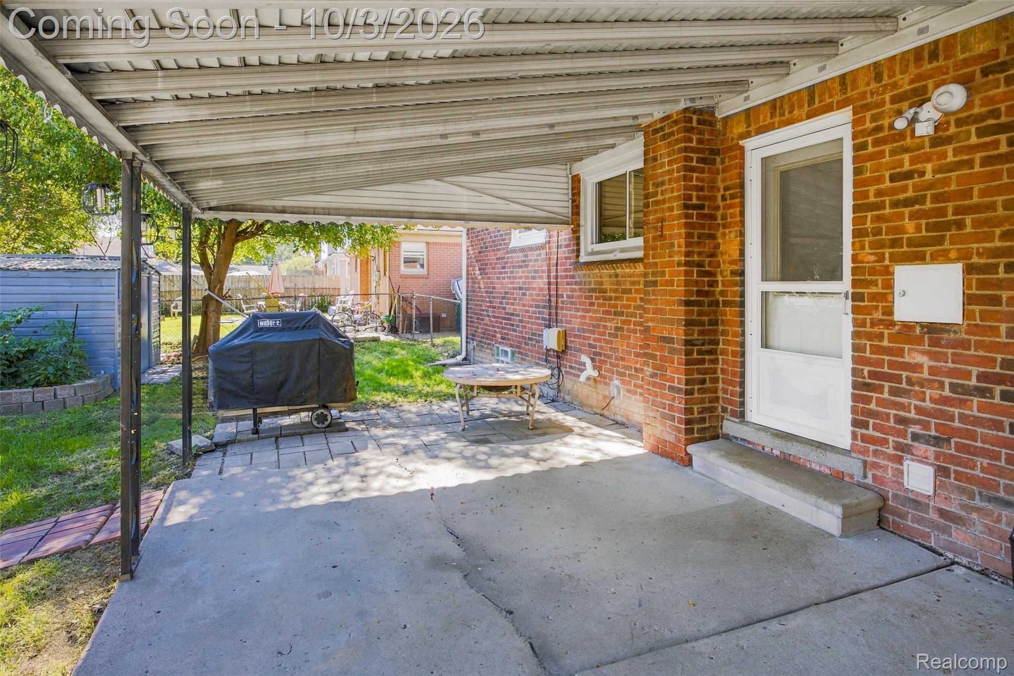 556 Henry Ruff Road Garden City, MI 48135 - Photo 34 of 49 Covered concrete patio with brick exterior and white door