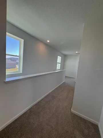 an empty room with windows and entrance