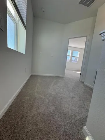 a view of an empty room with a window