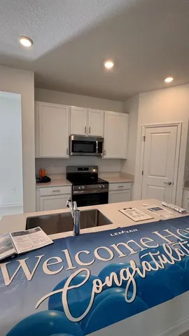 a kitchen with granite countertop a sink and a stove top oven