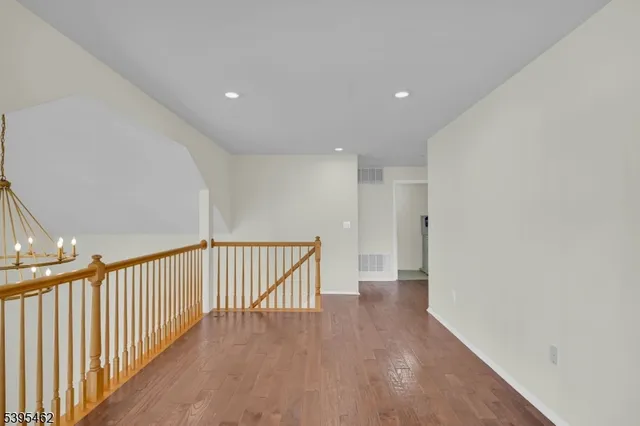 a view of hallway with wooden floor