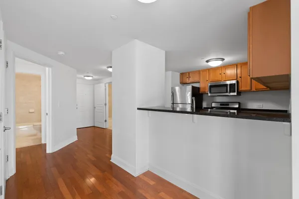 a view of a kitchen with a refrigerator a stove top oven and a refrigerator