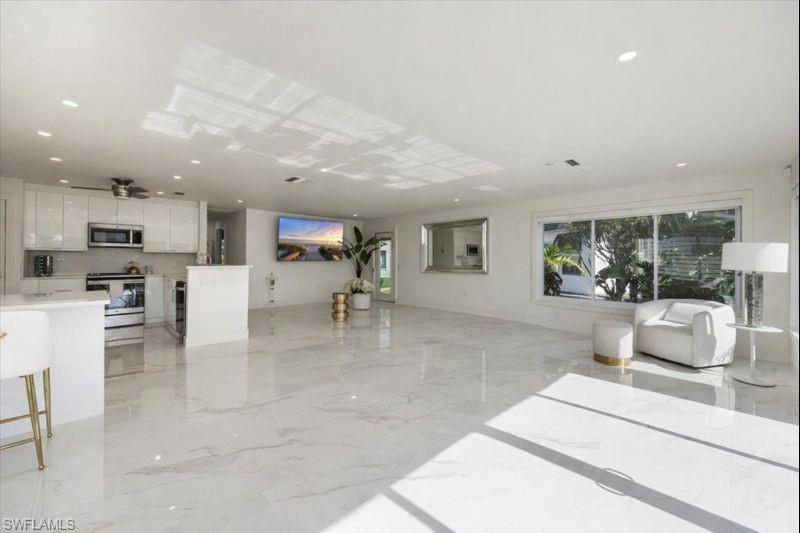 16 Knights Bridge Road Naples, FL 34112 - Photo 8 of 18 Living room with light marble finish floors and recessed lighting