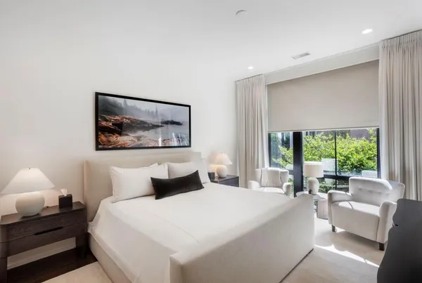 a bedroom with a large bed and a large window