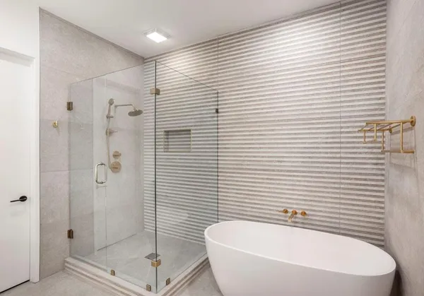 a bathroom with a white tub shower and a sink