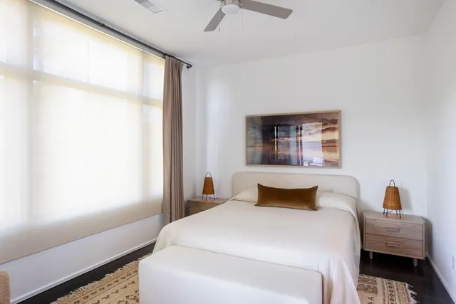 a bedroom with a bed and a window