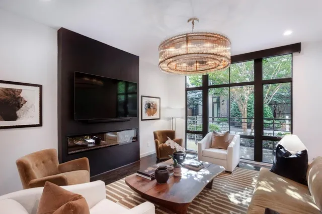 a living room with furniture a rug and a flat screen tv