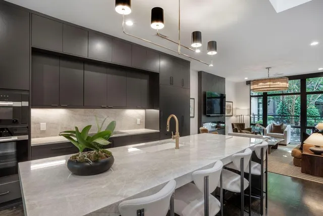 a kitchen with a table a potted plant and chairs