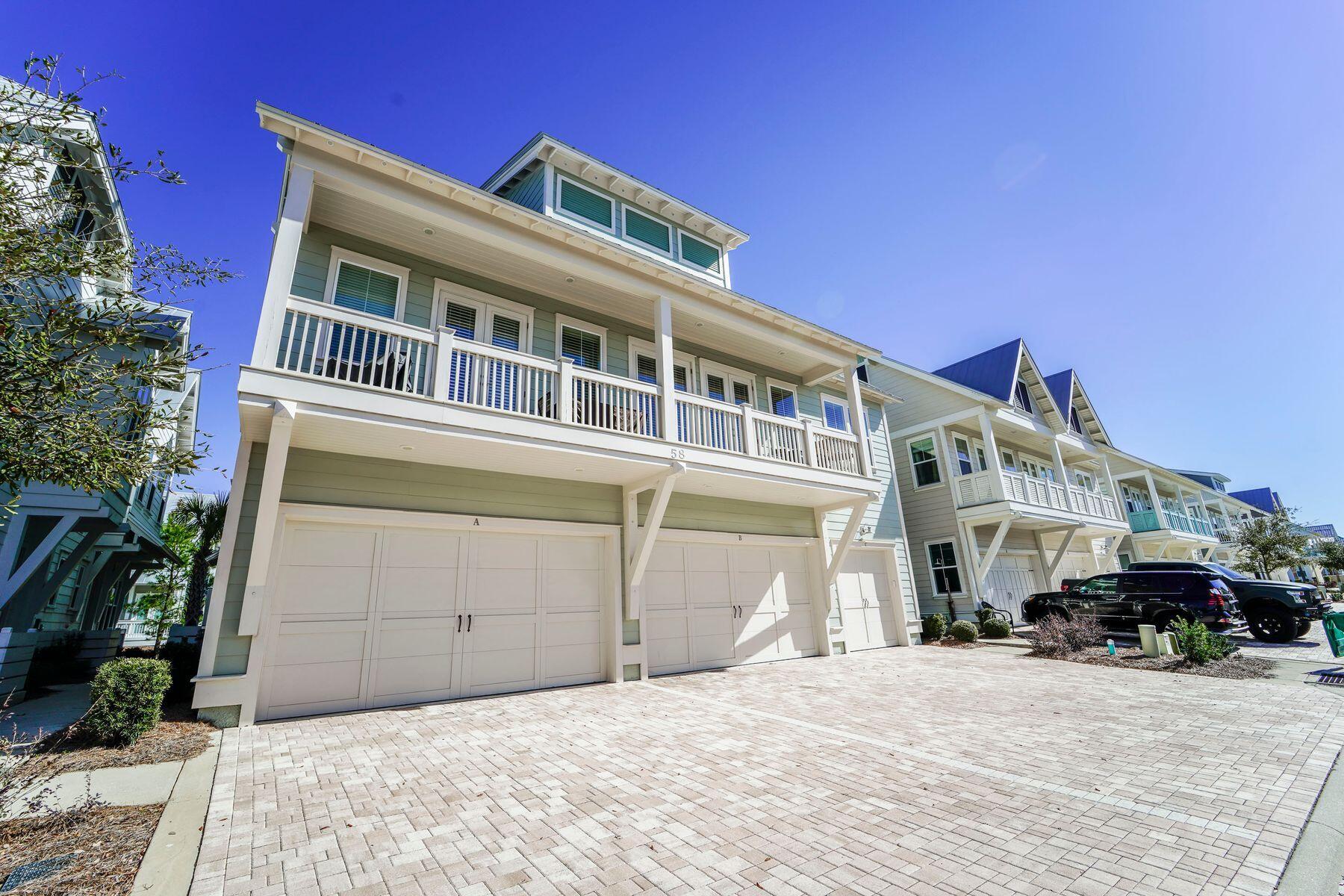 58 York Ln Inlet Beach, Unit B Inlet Beach, FL 32461 - Photo 1 of 24 a front view of a building with a garden and pathway